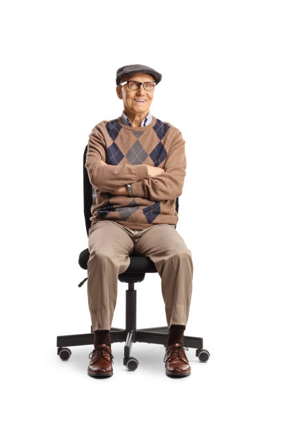 istock Pensioner sitting in an office chair and looking at camera 2150365190