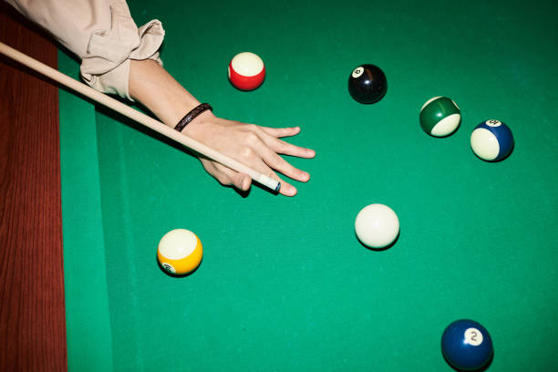istock Hand Holding Cue Stick and Playing Billiard at Pool Table 2150365251