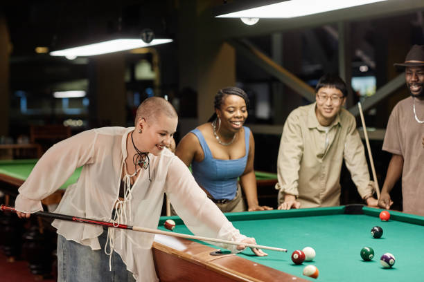 istock Smiling Bald Woman Playing Pool 2150365277