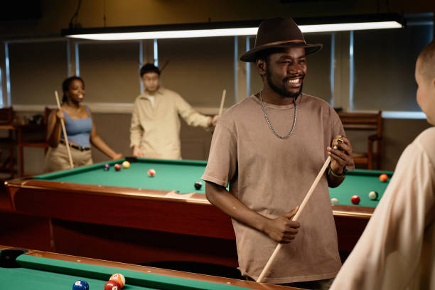 istock Black Man Chatting with Friend in Pool Club 2150365281