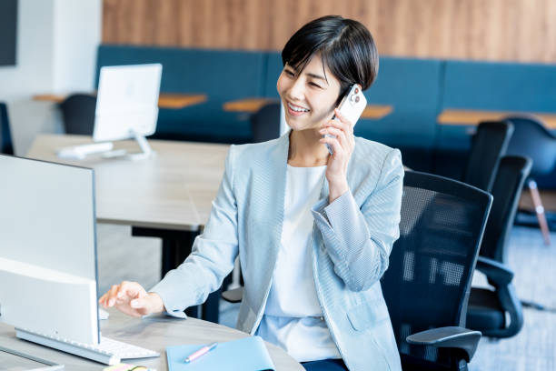 istock Business woman with smartphone in office 2150365718