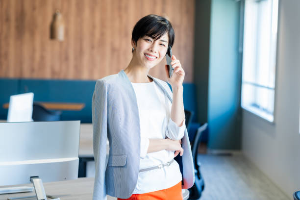 istock Business woman with smartphone in office 2150365950