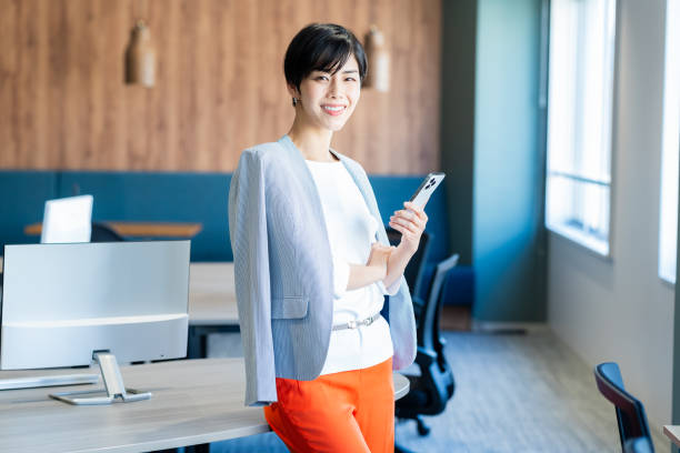 istock Business woman with smartphone in office 2150365980