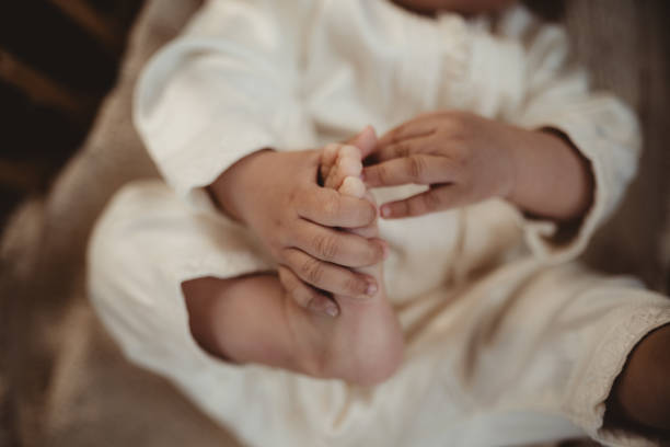istock Baby holding his toes with his hands 2150367670