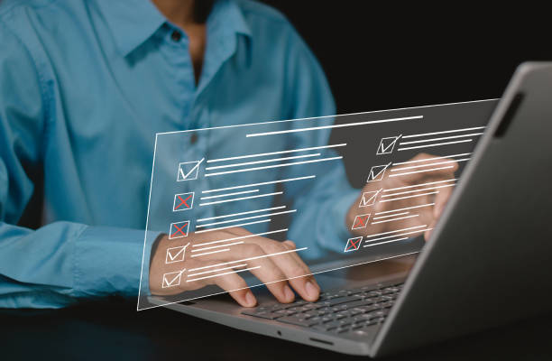 istock businessman using laptop doing online checklist survey, filling out digital form checklist. Fill out online surveys, answer quiz questions. 2150369230
