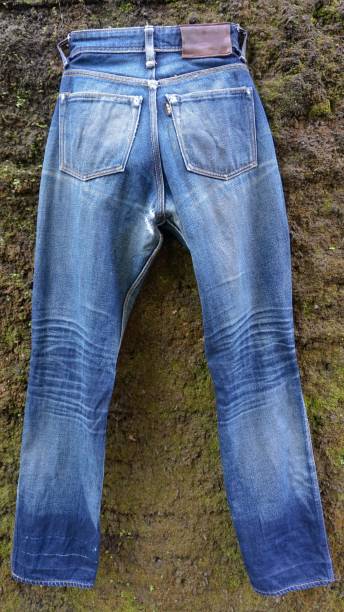 istock Jeans that have faded to light blue, with a wall in the background 2150372404