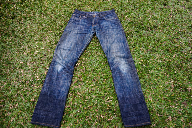 istock A pair of faded jeans, on green grass 2150372437