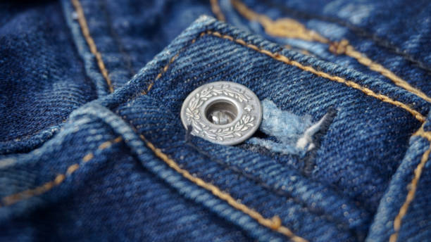 Close up of silver jeans buttons