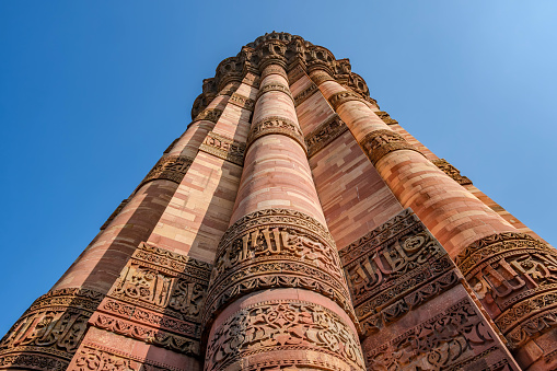 Delhi, India - March 10 2024: The Qutub Minar at Delhi India. The height of Qutub Minar is 72.5 meters, making it the tallest minaret in the world built of bricks.