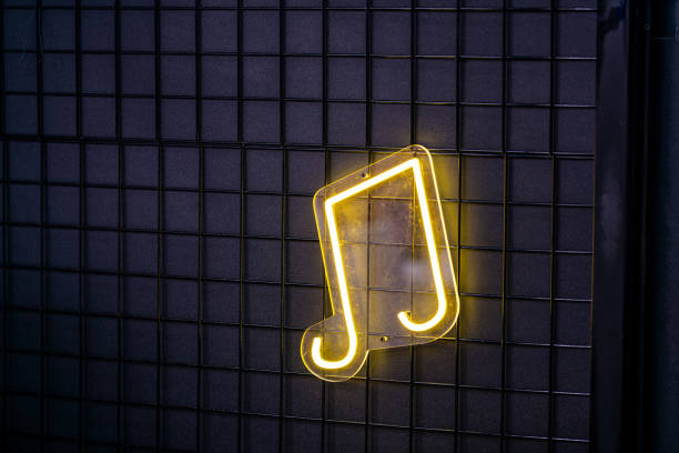 Neon yellow music symbols on the wall