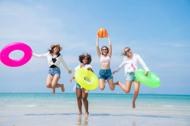 istock Group of teenage with floaty on the beach having fun. 2150375007