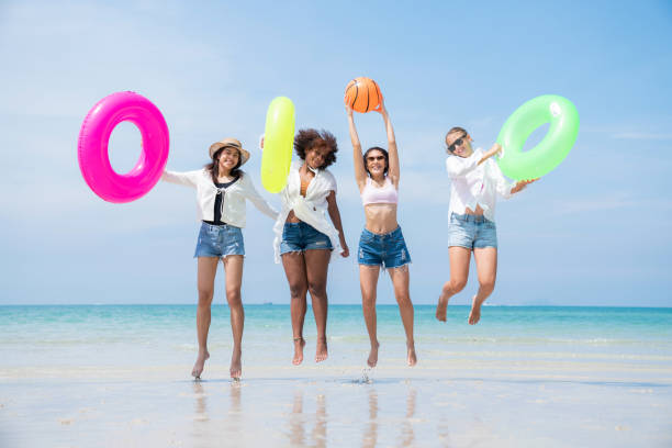 istock Group of teenage with floaty on the beach having fun. 2150375219