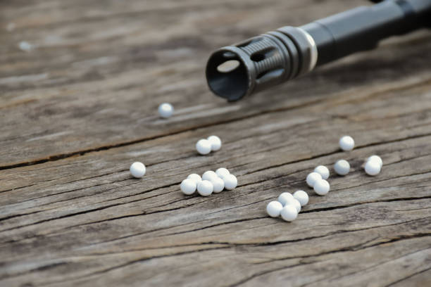istock white plastic bullets and airsoft gun or bb gun 2150375556