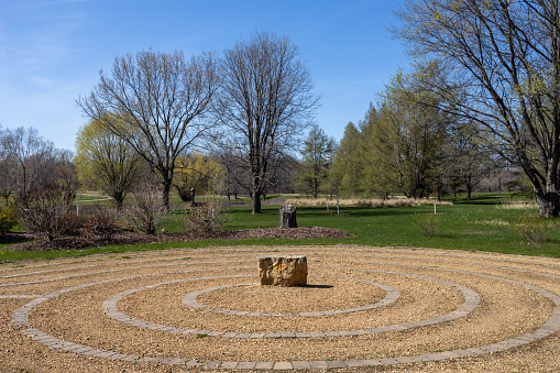 St. Peter, Minnesota, USA - April 24, 2024: This image shows a walking stone labyrinth made of limestone at the Arboretum at Gustavus Adolphus College.