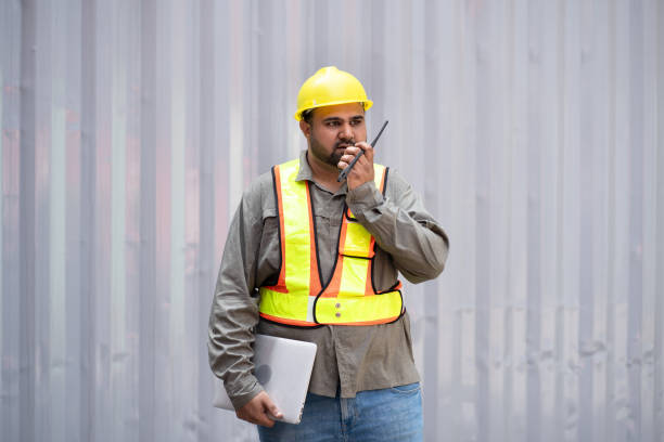 istock Middle east logistic worker foreman use walkie talkie working at container site 2150377329