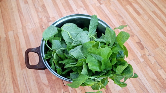 Fresh spinach leaves in a pan
