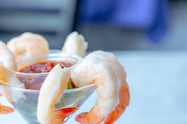 Shrimps salad with ginger and chili in mango sauce on wooden background