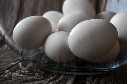 White eggs from hen, raw, not boiled.. Wooden background.