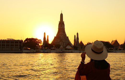 Woman Being Impressed with the Gorgeous Sunset View of Wat Arun or the Temple of Dawn, One of the Best Known Landmarks of Thailand, ( Self Portrait )