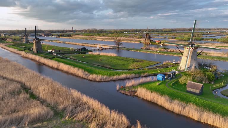 Aerial View to the wooden windmills at sunset in the Netherlands village