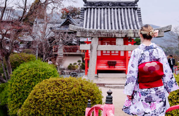 istock Young beautiful woman visiting  temple 2150386241