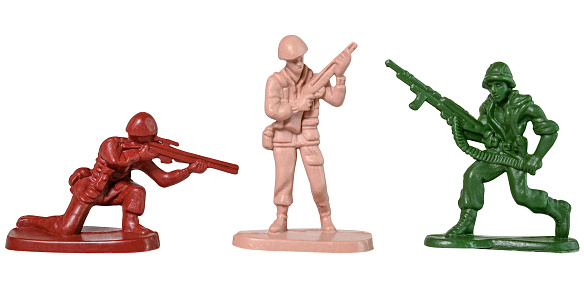 Traditional multicolored toy soldiers isolated on a white background.