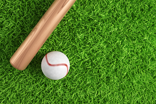 Baseball ball and bat on green grass with copy space. 3d-rendering