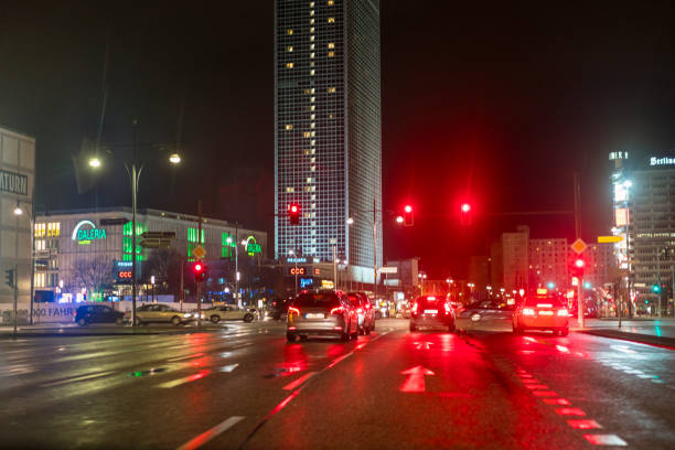 Modern architecture at Alexander Platz in Berlin. The modern architecture is particularly impressive at night. The picture shows a traffic jam at Alexanderplatz.