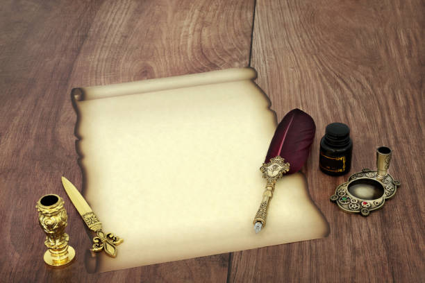 Parchment paper scroll with old feather quill pen, ink, letter opener. Retro writing equipment for vintage manuscript, diploma, document, letter on rustic wood.