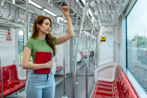 istock Pensive Woman with Tablet in Sparse Metro Car 2150392415