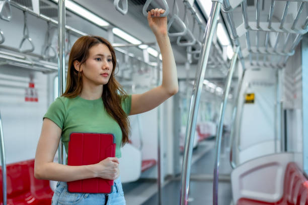 istock Pensive Woman with Tablet in Sparse Metro Car 2150392421