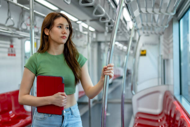 istock Pensive Woman with Tablet in Sparse Metro Car 2150392422