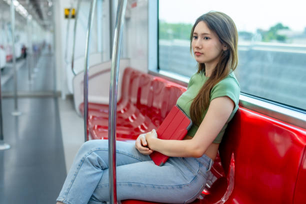 istock Contemplative Woman with Tablet on Quiet Train. 2150392424