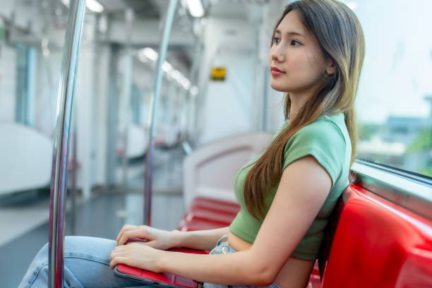 istock Contemplative Woman with Tablet on Quiet Train. 2150392431