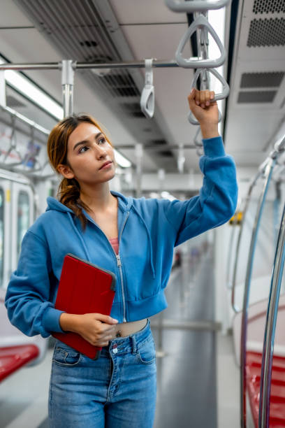 istock Confident Woman Holding Tablet in Subway Car. 2150392448