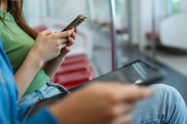 istock Close-up of Woman Using Smartphone on Train. 2150392458
