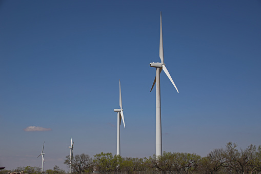 Row of electric windmill generators as seen in Mitchell County, Texas.