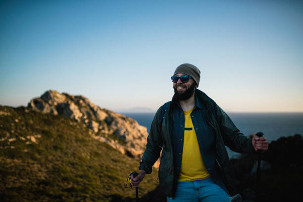 istock Tourist hiking in mountains at sunset 2150394062