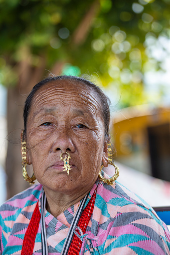 Kathmandu, Nepal - oct 23, 2016 : Elderly Nepali woman with traditional nose jewelry on the street market in Kathmandu, Nepal