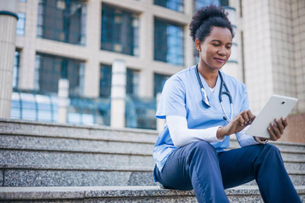 istock African female doctor using digital tablet outdoors. 2150394458