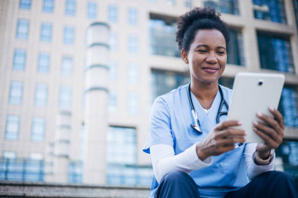 istock African female doctor using digital tablet outdoors. 2150394556