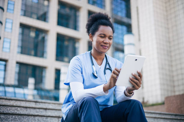 istock African female doctor using digital tablet outdoors. 2150394621