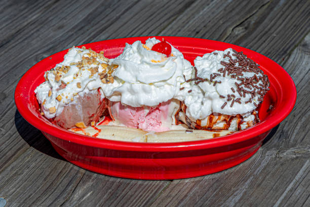 3 scoops of ice cream, banana split, strawberry, cherry, topping