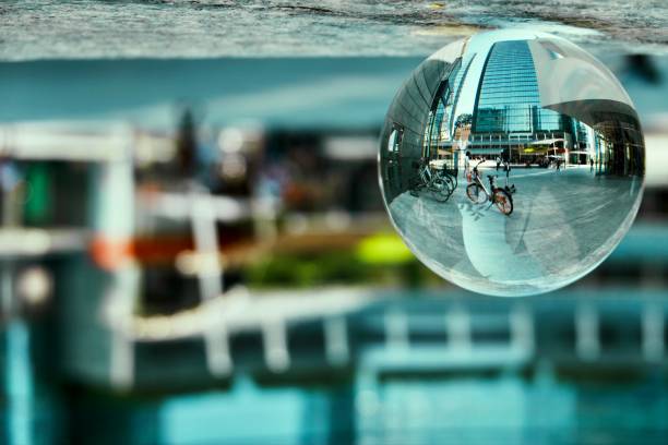Close-up of globe showing a map of the American continent and atlantic ocean and ship steering wheel model for world travel concept and shipping maritime business on blurred table background.