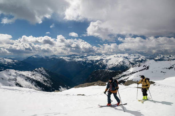istock Backcountry skiers climb mountain 2150396193