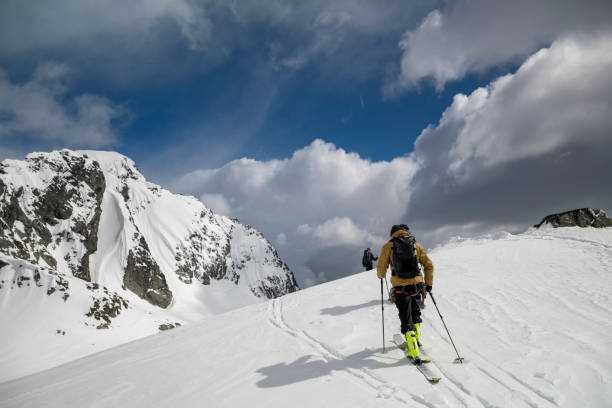 istock Backcountry skier climbs mountain 2150396249
