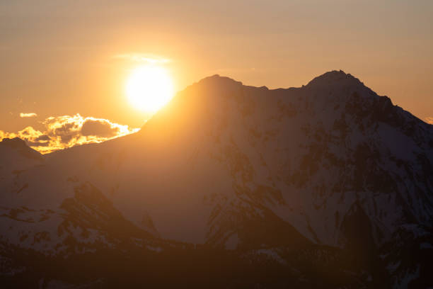 Mature backcountry skier ascends mountain, Tantalus Ranges