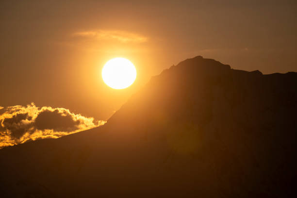 Mature backcountry skier ascends mountain, Tantalus Ranges