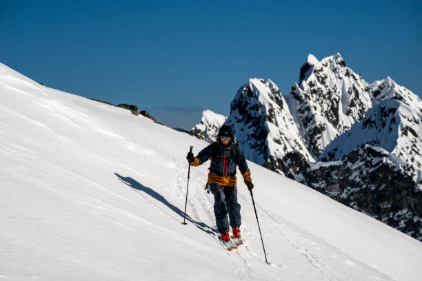 istock Backcountry skier climbs mountain 2150396453