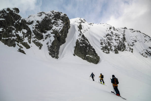 istock Backcountry skiers climb mountain 2150396457